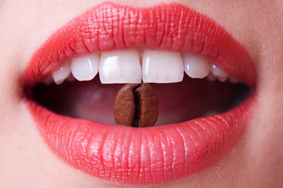coffee bean in a female mouth